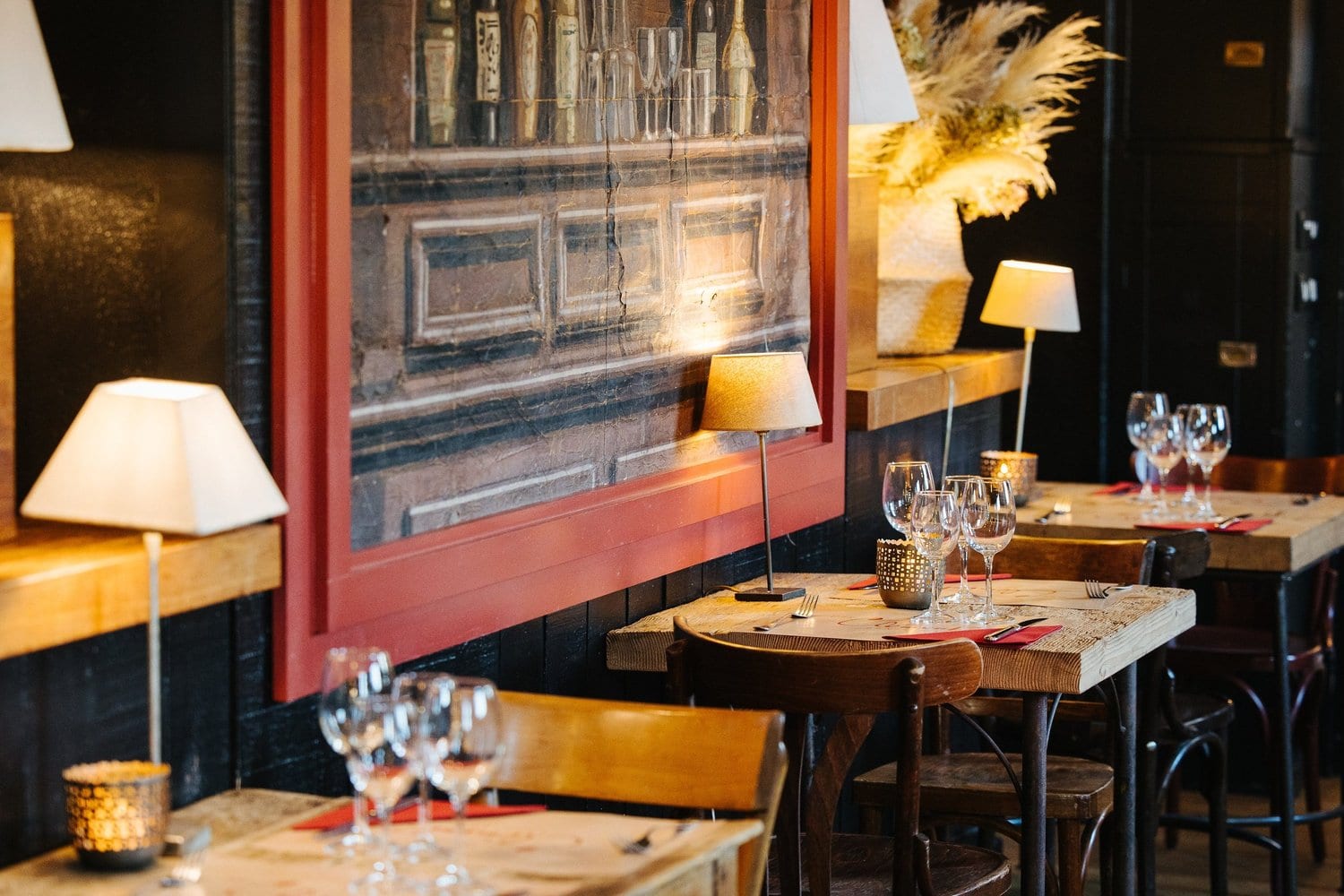 Warm brasserie interior with set tables and pendant lights